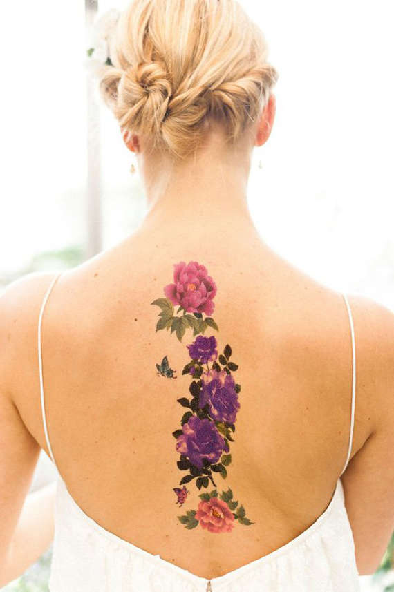 Artistic flower tattoos on back of a women