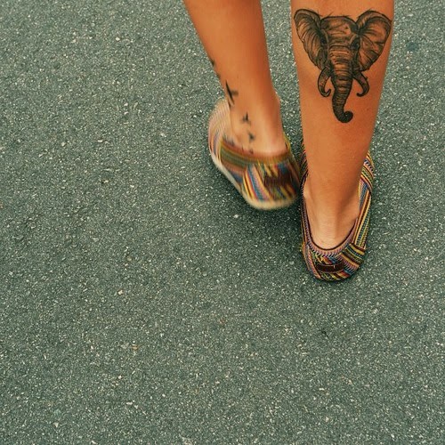 Elephant head tattoo design on leg.