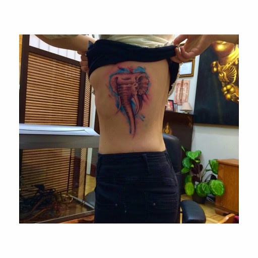 Watercolor Elephant head tattoo designs for girls on ribs.