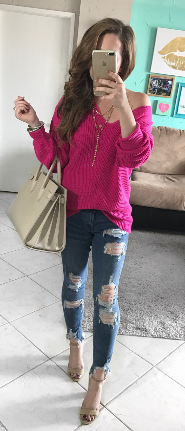 women's pink off-shoulder long-sleeve shirt with blue distressed denim jeans