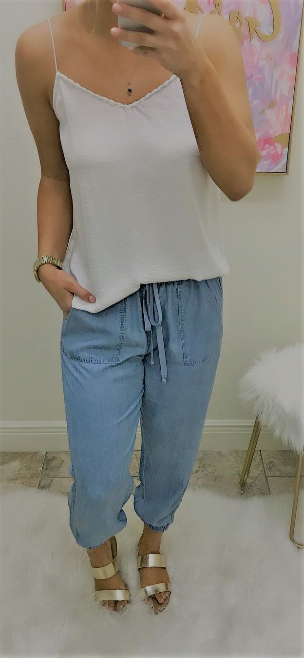 Denim pants paired with a simple white top and our gold flat sandals.