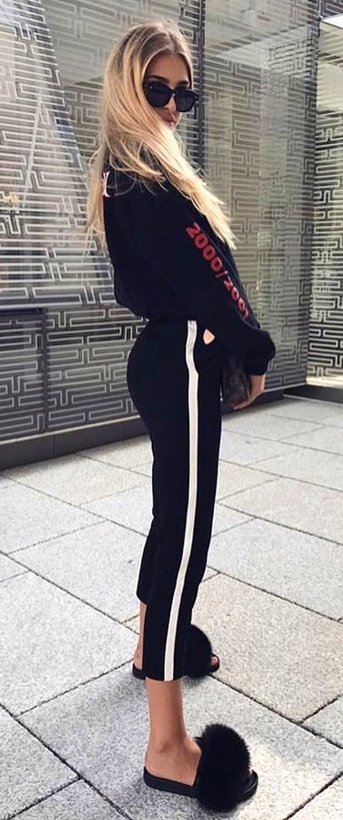 Woman in black and white sweat pants.