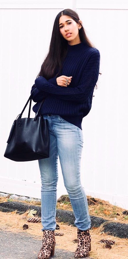 Woman wearing blue crew-neck long-sleeved shirt and blue jeans.