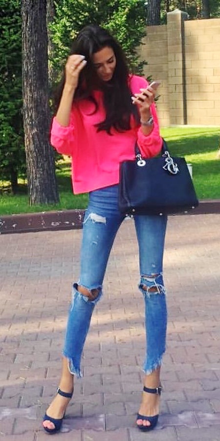 Pink quarter sleeve shirt with ripped jeans.