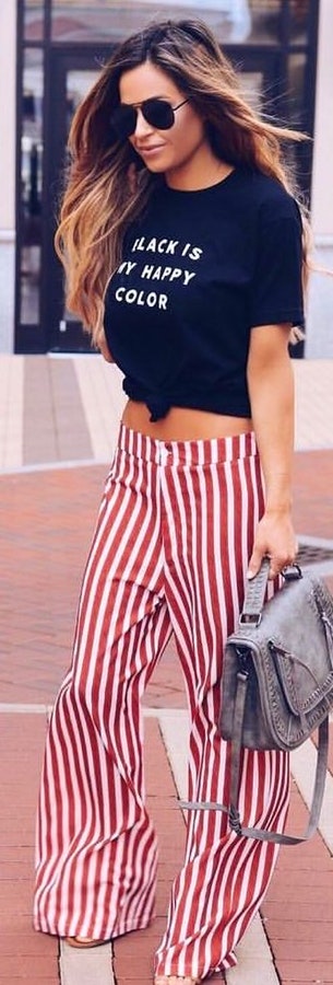 Black crop top with red and white stripe pant, gray two-way bag and sunglasses.