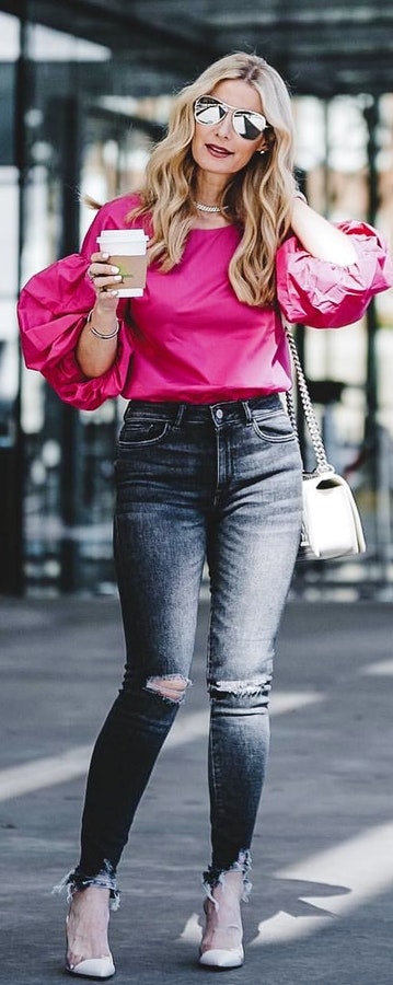 Distressed black jeans, high heels and pink long-sleeved shirt.