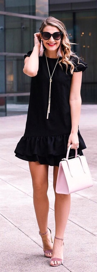 Handbag, high heels with black mini dress and oversize sunglasses.