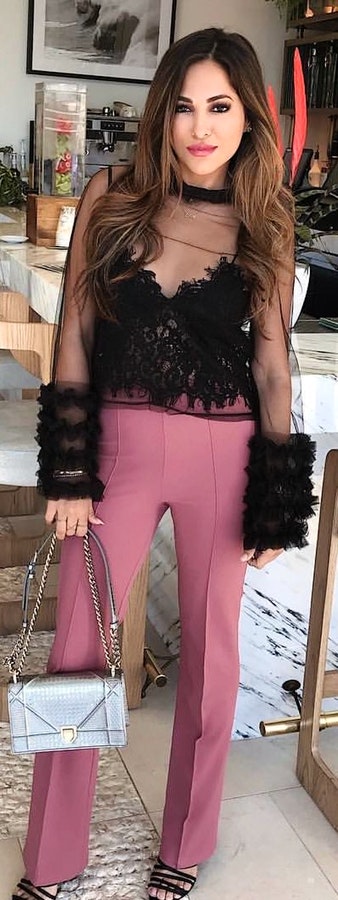 Lace top and maroon pants, white handbag and black high heels.