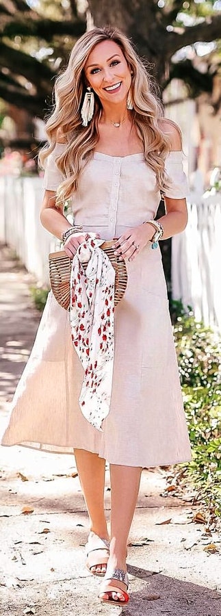 White off-shoulder dress with flat.