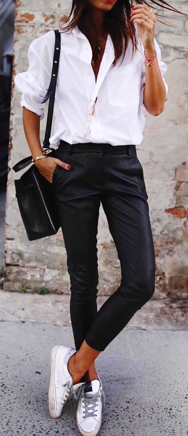 White shirt with black pants and pair of white low-top sneakers outfit.