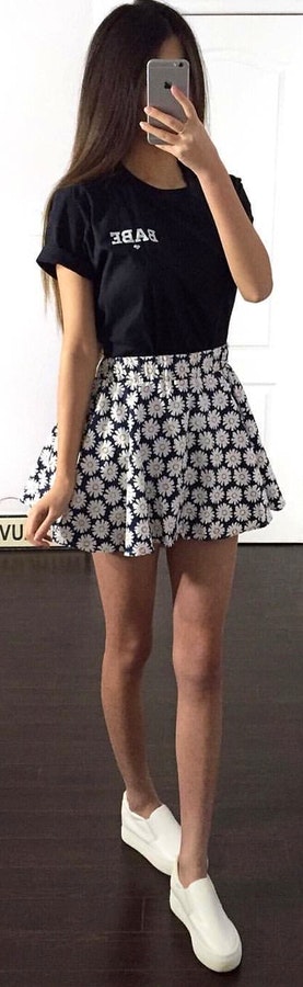 Black crew-neck shirt and white floral mini skirt.