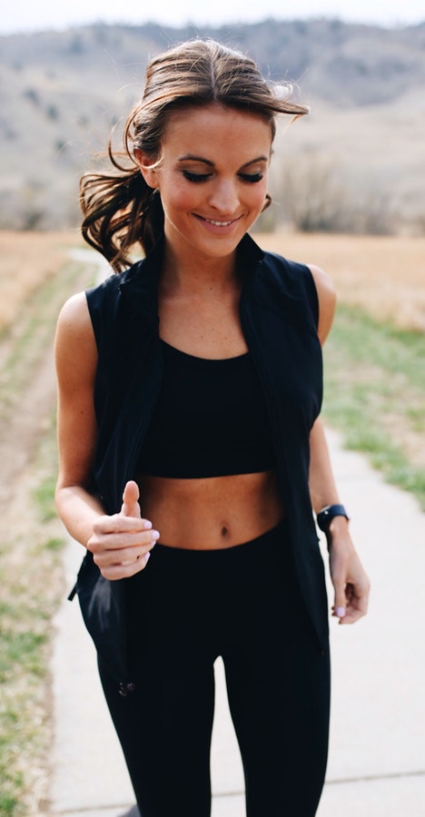 Black sleeveless cardigan, leggings, and sleeveless crop top set.