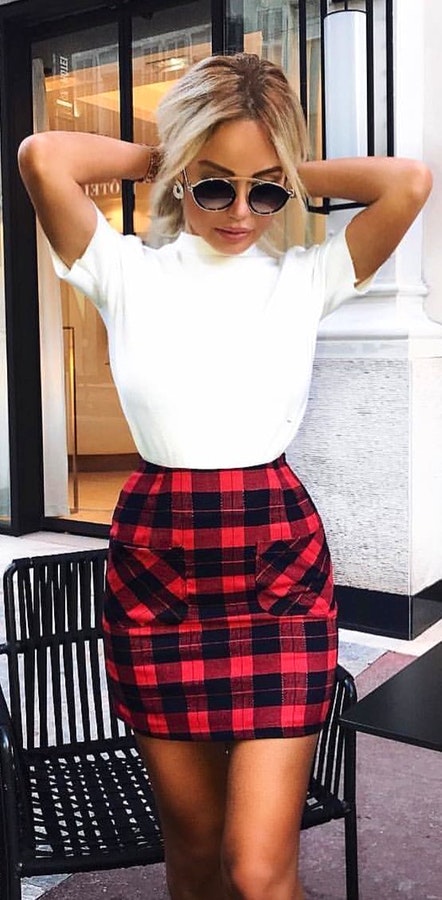 White crew-neck t-shirt and red and black plaid mini skirt.