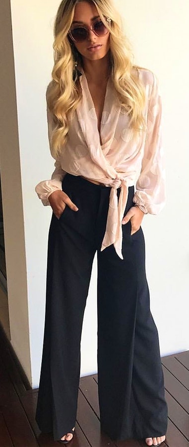 women's beige deep v-neck long-sleeved shirt and black flare pants outfit.