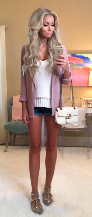 women's pink cardigan; white tank top; blue denim short shorts.