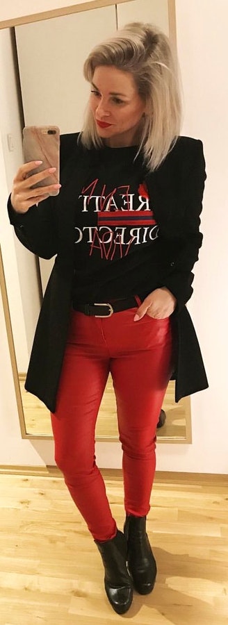 Black blazer and red denim jeans.