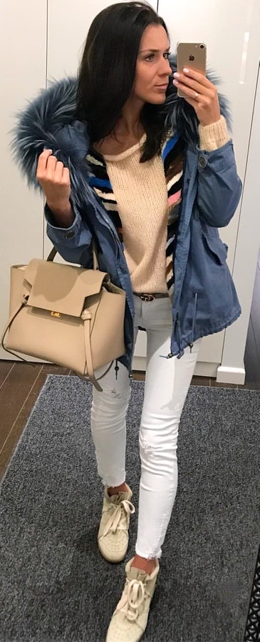 Brown scoop-neck sweater, blue zip parka coat and white skinny jeans outfit.