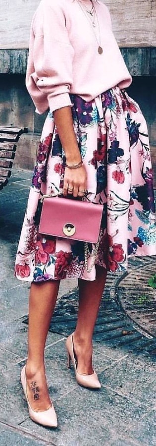 Woman in pink and purple floral skirt.