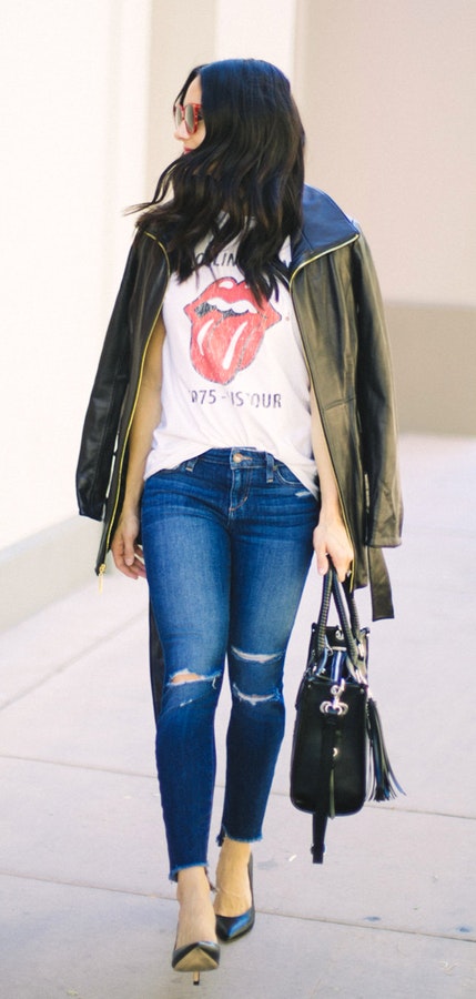 Women's black leather zip-up jacket, white shirt, distressed denim fitted jeans, and blue leather pointed-toe pumps.