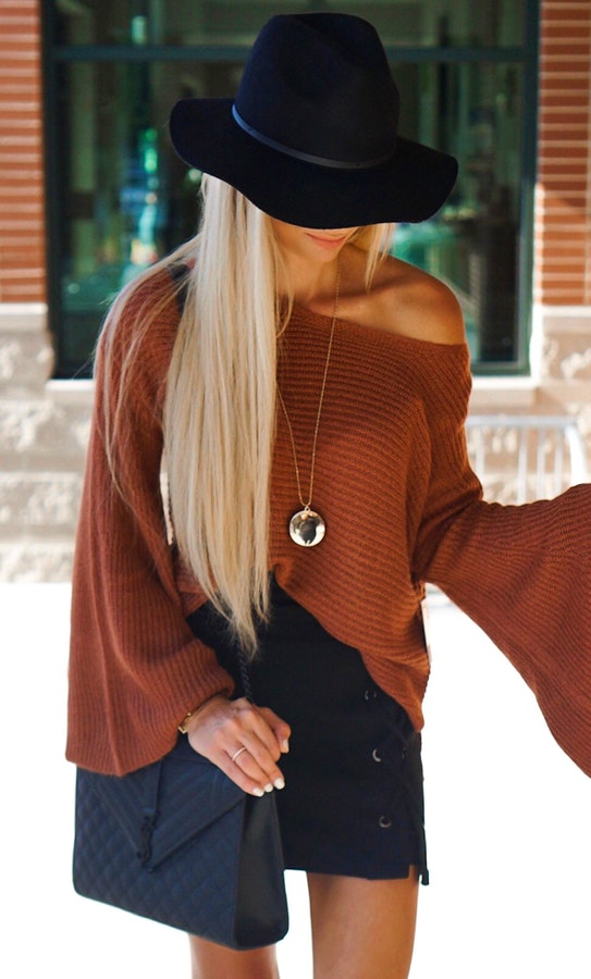 Women's brown off-shoulder long-sleeved shirt and black sun hat.