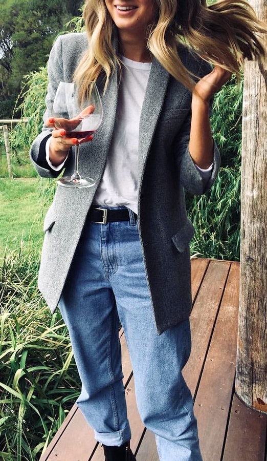 Women's gray blazer, white top, and blue jeans.