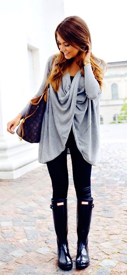 Women's gray cardigan, black bottoms, and black wellington boots.