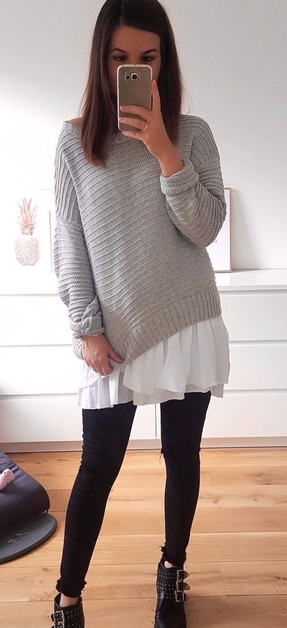 Women's knitted gray crew-neck sweater.