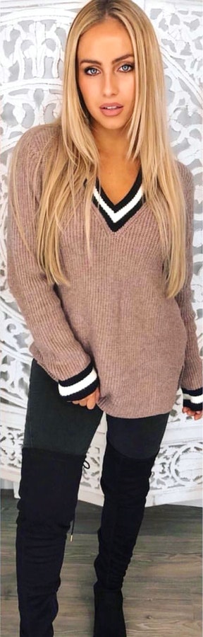 Women's pink, black, and white V-neck sweater