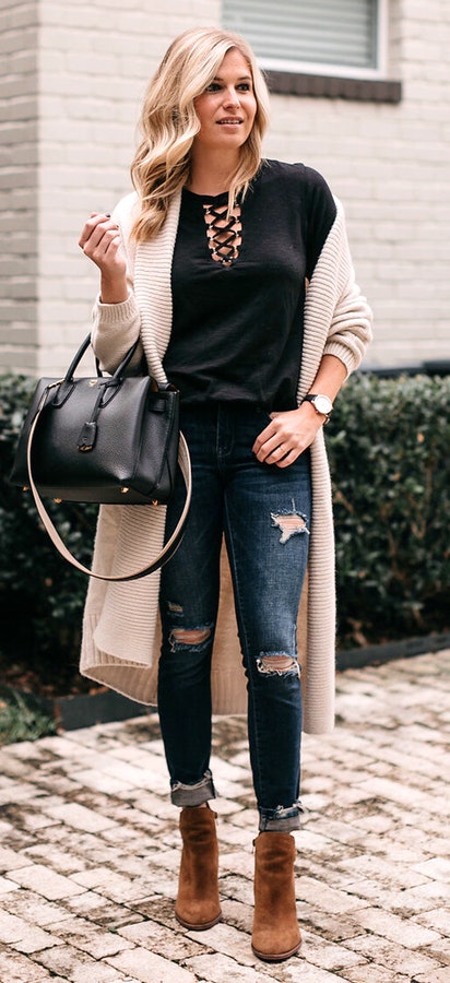 Women's white cardigan and black sleeved shirt.