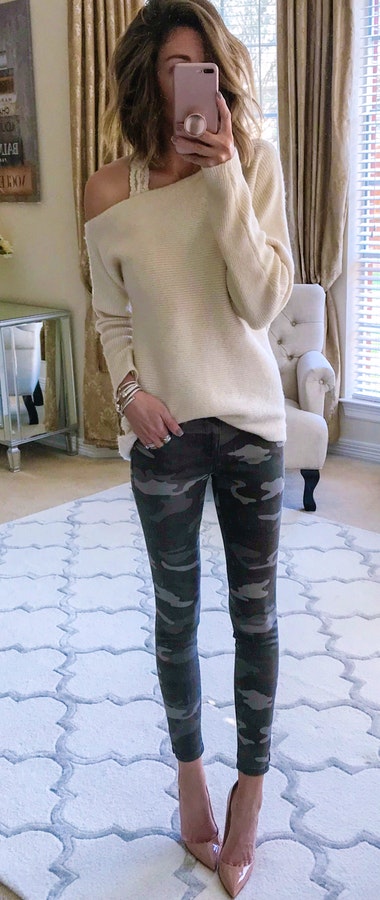 Women's white long-sleeved top with grey and black camouflage pants.