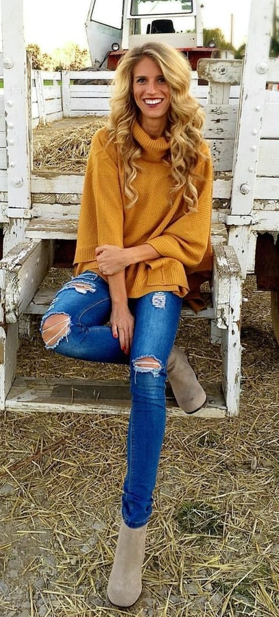 Women's yellow turtle neckline sweatshirt, distressed blue skinny jeans and brown suede leather boots outfit. Fresh Fall Outfits