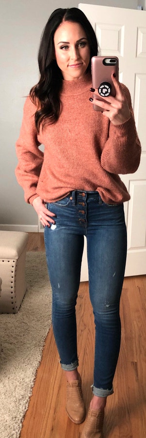 Woman in brown sweater.