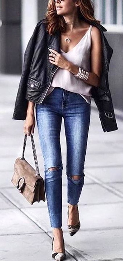 Woman wearing black denim jacket.