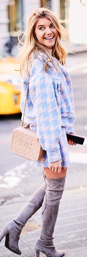 Woman wearing blue and white houndstooth print jacket.