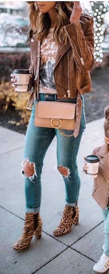 Woman wearing distressed gray fitted jeans.