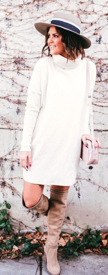 Woman wearing white long-sleeved dress looking at her right side.