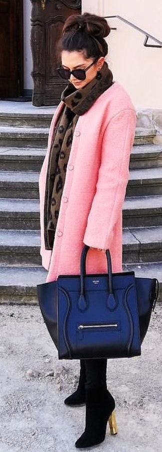 Black leather tote bag and pink coat.