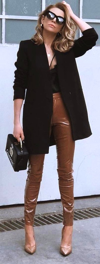 Woman brown leather pants and black coat.