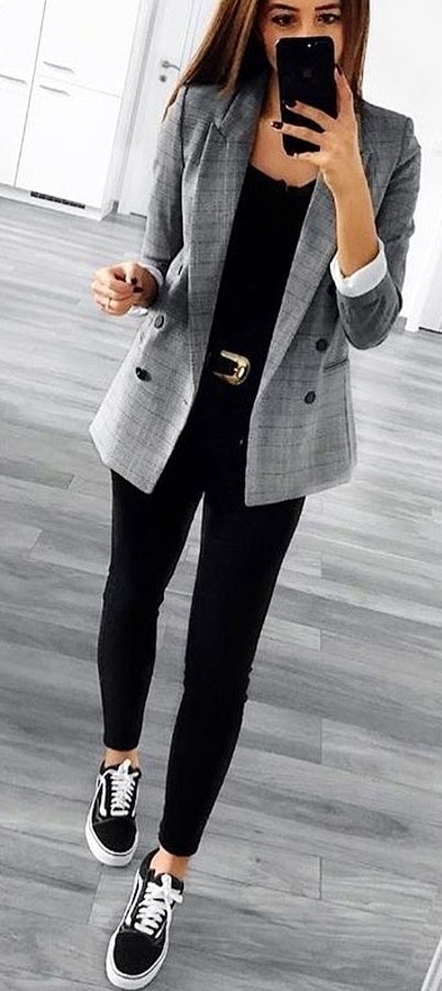 Woman in gray blazer and black pants.