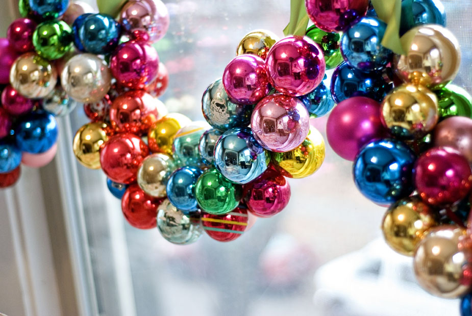 String baubles onto a ribbon.