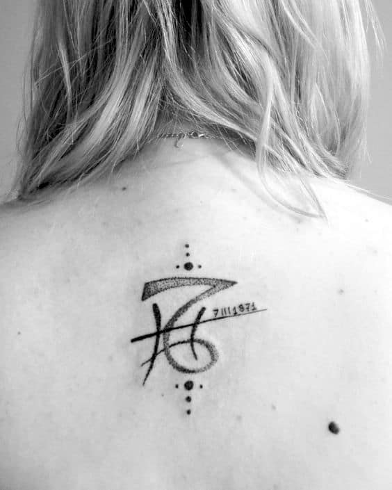 Back tattoo combining Pisces and Capricorn.