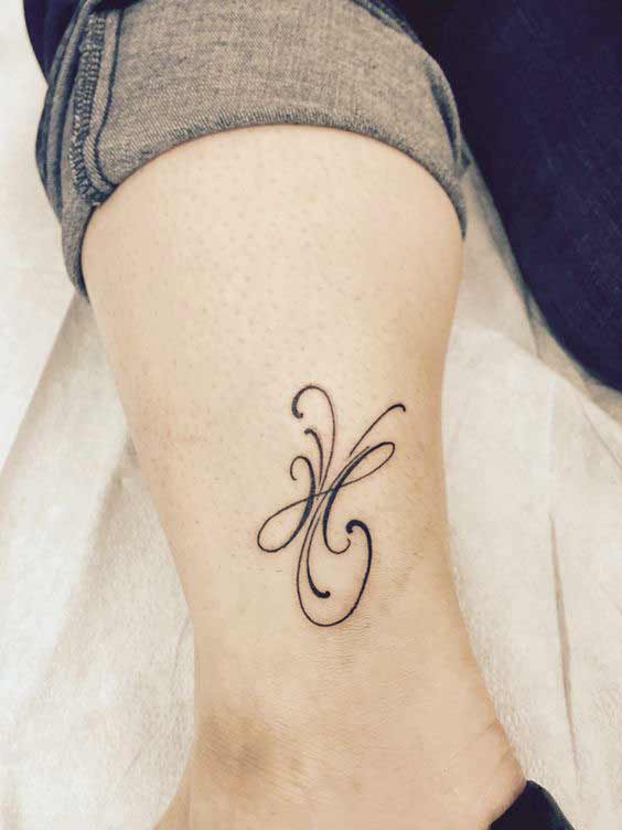 Beautiful Pisces tattoo symbol design for girls on the leg.