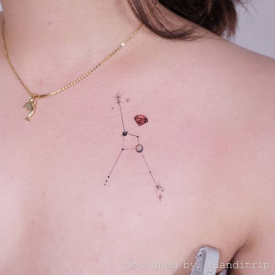 Cancer constellation and ruby tattoo on the chest.