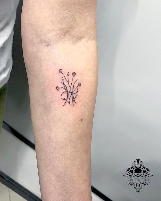 Floral forearm tattoo.