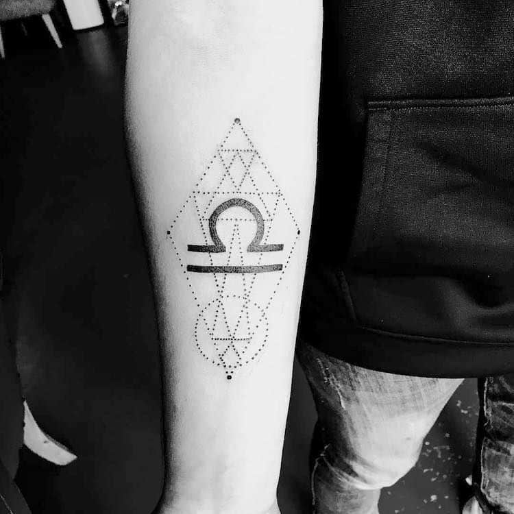 Geometric Libra sign symbol on the arm.