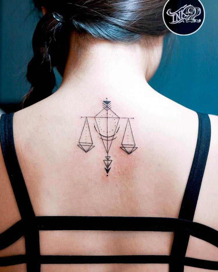 Geometric scale back tattoo.