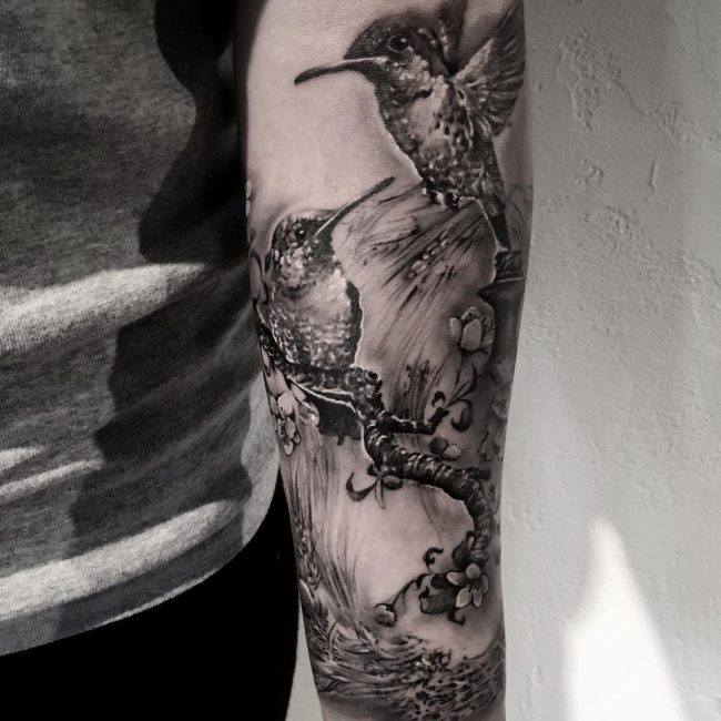 Birds tattoo on back arm.