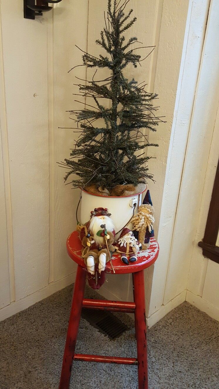 Farmhouse christmas tree in vintage enamel pot and vintage stool