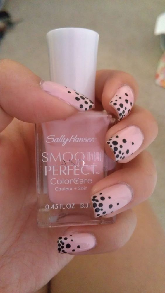 Pink and black polka dot nails.