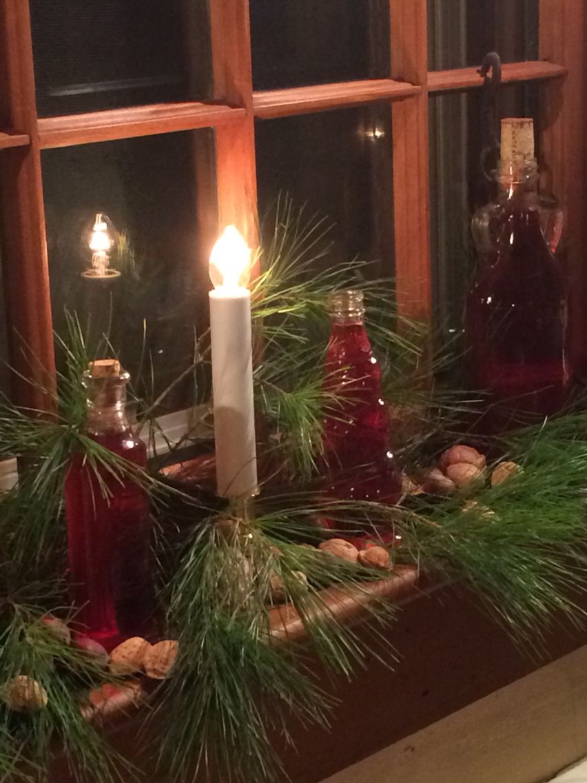 Window sill decorations. Just water with red dye in beautiful old jars.